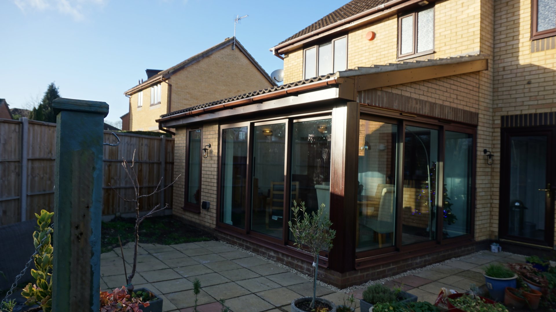 Contemporary home extension featuring wood effect aluminium sliding doors and tilt turn windows